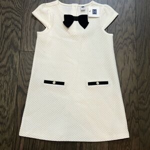 Janie and Jack dress brand new. Size 5. Cream with black bow.